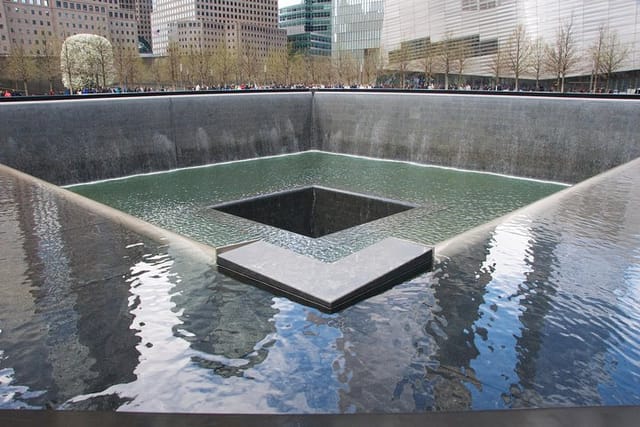 2 WTC-South Tower Reflecting Absence Memorial Pool At 9/11 Memorial At Ground Zero-Springtime 